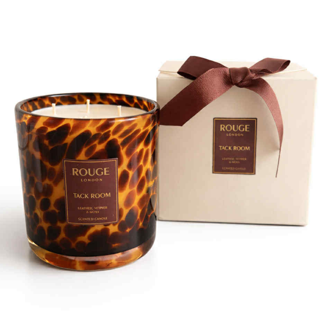 Tack Room 3 wick Candle with a tortoiseshell pattern. Leather, Vetiver & Moss next to a luxury cream box with ribbon