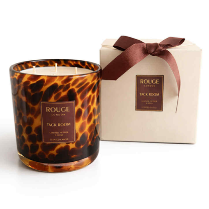 Tack Room 3 wick Candle with a tortoiseshell pattern. Leather, Vetiver & Moss next to a luxury cream box with ribbon