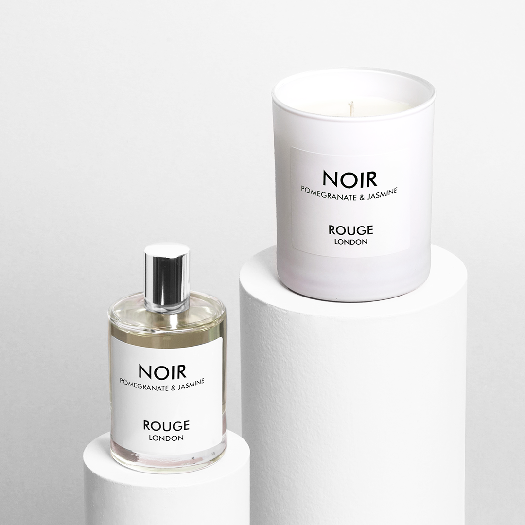 A luxury candle and room spray set, with the candle labeled 'NOIR' and the room spray labeled 'ROUGE LONDON'