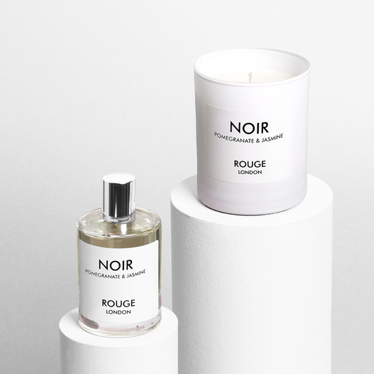A luxury candle and room spray set, with the candle labeled 'NOIR' and the room spray labeled 'ROUGE LONDON'